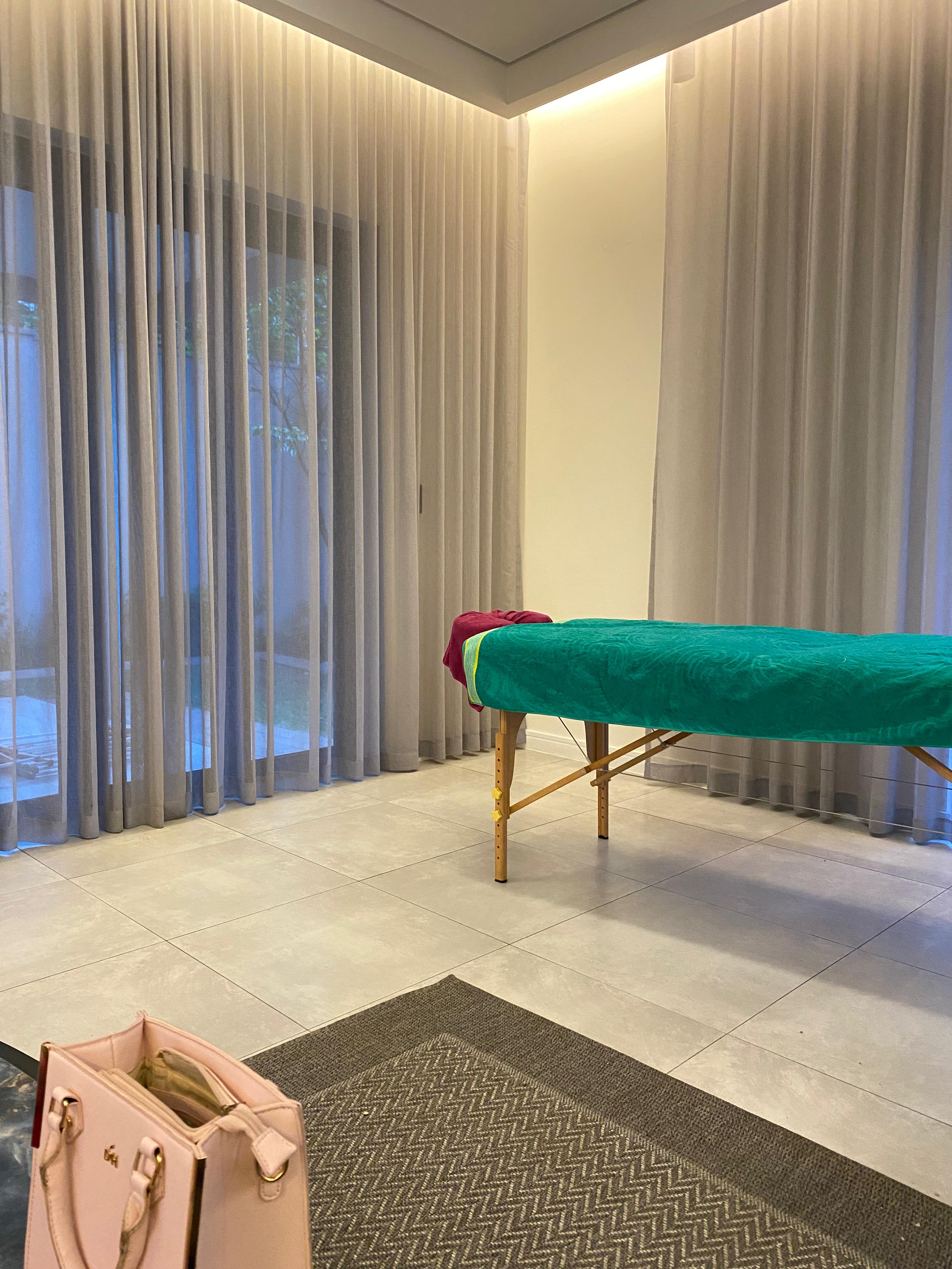 Professional massage table setup with oils and spa equipment